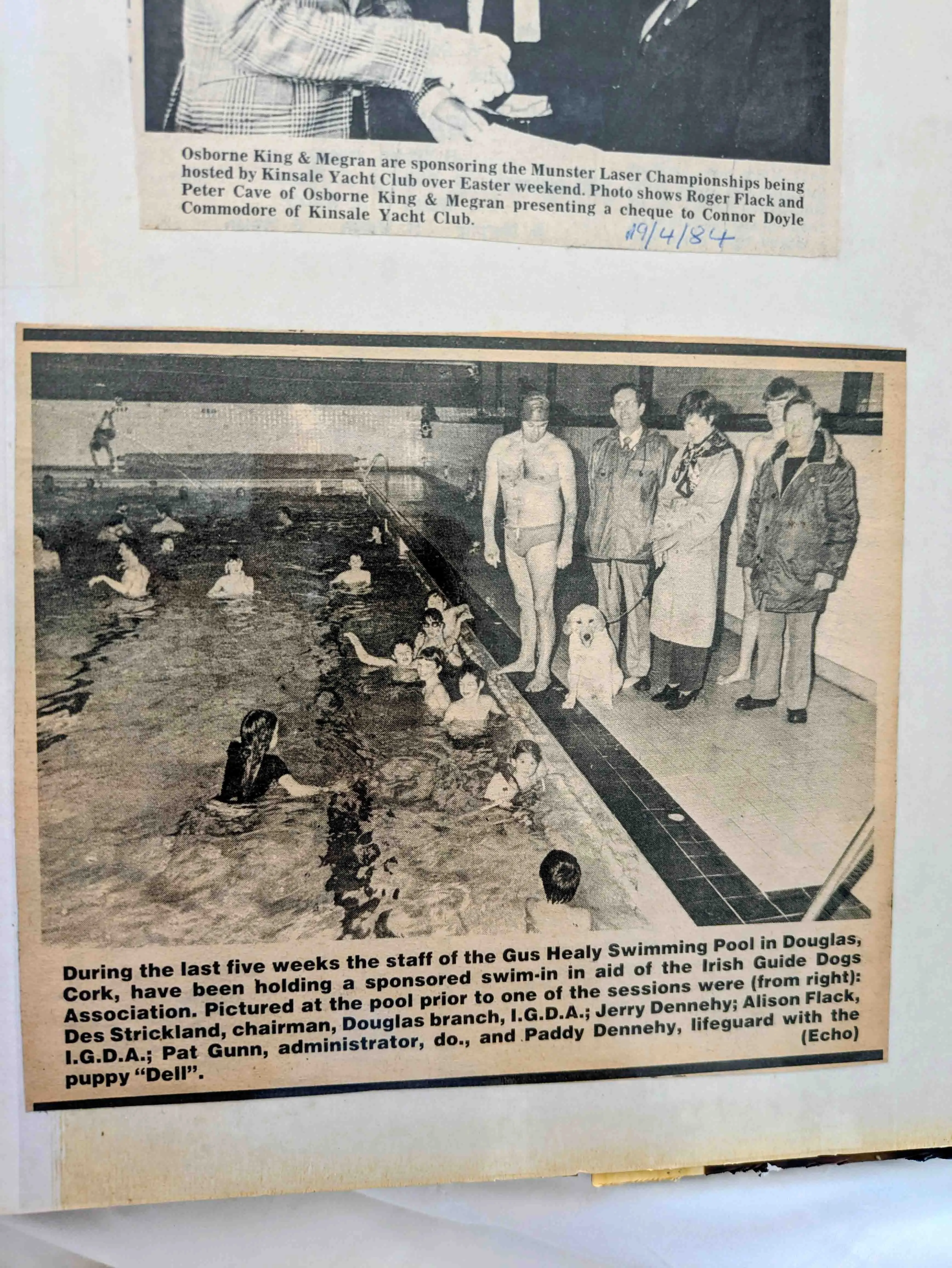 # Alt Text A newspaper clipping shows staff members and officials standing poolside at the Gus Healy Swimming Pool in Douglas, Cork, during a sponsored swim-in organized by the Iri